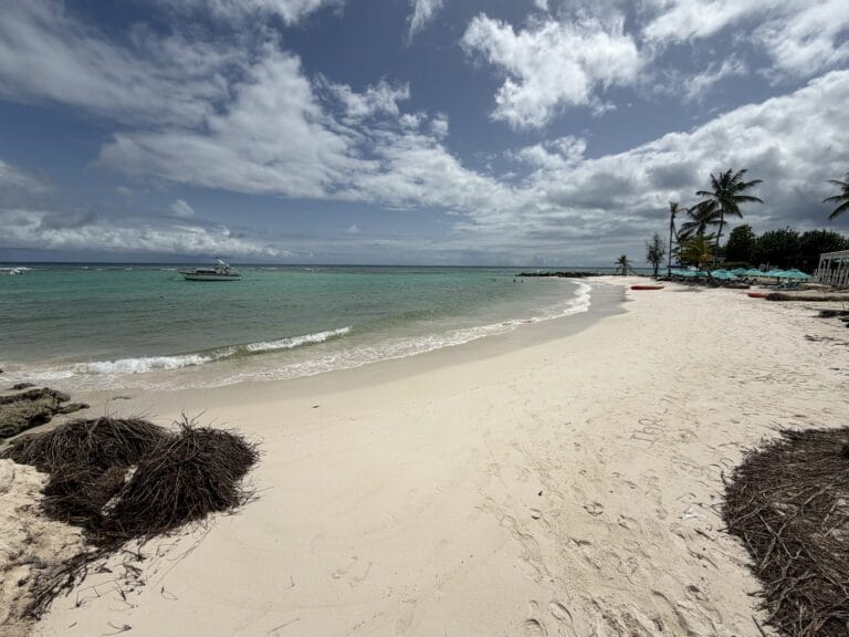 White sand curving along turquoise water at Worthing Beach, Barbados